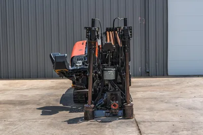 2017 Ditch Witch JT20 HDD rig, rear view showing drill frame, hydraulic lines, anchors, vise, and orange engine hood with operator seat