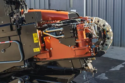 2023 Ditch Witch JT20 drill carriage, vise assembly, hydraulic hoses, and drivetrain components from a side perspective.