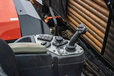2024 Ditch Witch JT24 operator controls: joystick, button panel, armrest; used 10ft drill pipe rack visible right