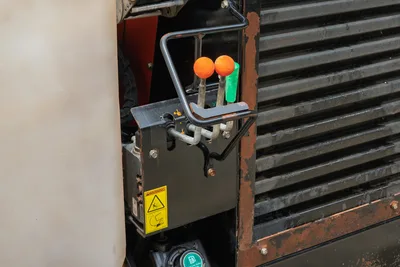 2018 Ditch Witch JT10 HDD control levers and engine compartment radiator grille with orange and green shift handles.