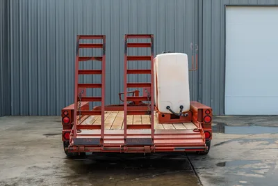 2019 Belshe WB14-2EP mud trailer, rear view, red steel frame, wood deck, dual ramp ladders, white poly water tank with fittings