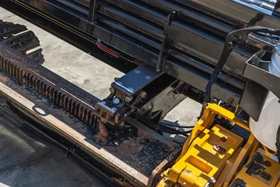2019 Vermeer D40x55 S3 drill frame close-up showing rack-and-pinion thrust system, carriage, hydraulic hoses, and yellow spindle assembly