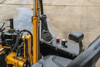 2018 Vermeer D8x12 operator controls: joystick, red E-stop button, ignition switch, armrest, hydraulic hoses, drill frame
