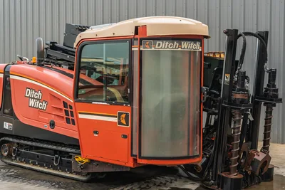 2012 Ditch Witch JT3020 directional drill, side profile showing operator cab, steel tracks, and drill pipe entry assembly.