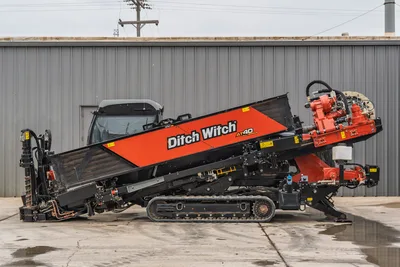 Side view of 2021 Ditch Witch AT40 All Terrain HDD drill featuring full tracks, enclosed cab, and pipe box in good condition.