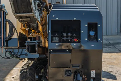 2016 Vermeer D23x30 S3 operator console closeup showing control panel, joysticks, hydraulic lines, tracks, and drill frame