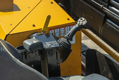 2022 Vermeer D23x30 S3 operator controls closeup showing joystick, throttle lever, armrest, and safety decals
