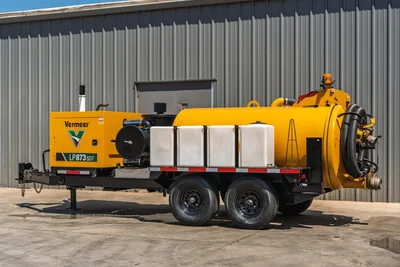 2025 Vermeer LP873SDT trailer-mounted vacuum excavator, driver-side view, yellow debris tank, white water tanks, dual axle