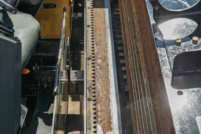 Vermeer 10x15 S3 drill pipe rack and rotary drive components, overhead angled view showing wear and operational use