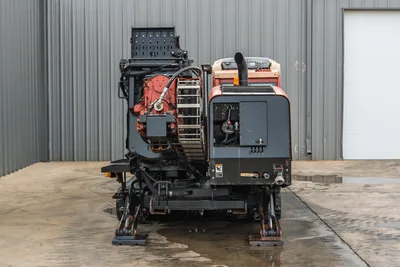Rear view of 2012 Ditch Witch JT3020 Mach 1 drill showing engine compartment, carriage, drill pipe rack, and stabilizers.