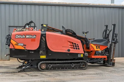 2021 Ditch Witch JT28 HDD drill, driver-side profile, rubber tracks, drill pipe loaded, carriage, hydraulic lines visible