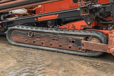 2008 Ditch Witch JT4020 MACH 1 rubber track undercarriage, drill pipe rack, and rack-and-pinion drive assembly.