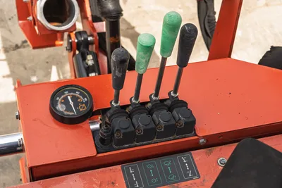 2017 Ditch Witch RT80 hydraulic control levers and pressure gauge on operator station platform.