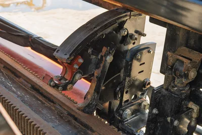 Close-up of Ditch Witch JT20 rack-and-pinion drill drive carriage, assembly, and hydraulic system components on rail.