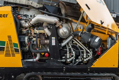 2016 Vermeer D23x30 S3 open engine compartment showing turbocharged diesel engine, exhaust, hydraulic lines, and air filter