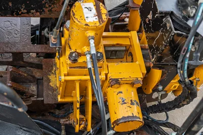 2016 Vermeer D23x30 S3 drill carriage overhead view showing hydraulic cylinders, hoses, and wear on yellow frame components
