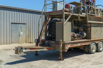 2018 Mud Technologies MCT-450 trailer-mounted mud recycler, front hitch angle, diesel engine compartment, pumps, piping, access stairs visible