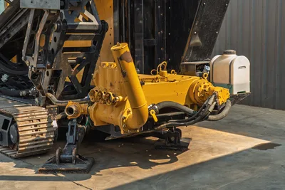 2017 Vermeer D100x140 S3 mud pump assembly, hydraulic manifold, stabilizer feet, steel tracks, and coolant tank visible at rear