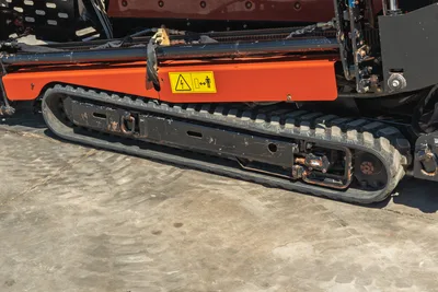 2021 Ditch Witch JT20 horizontal directional drill side view, highlighting black rubber tracks and orange undercarriage.