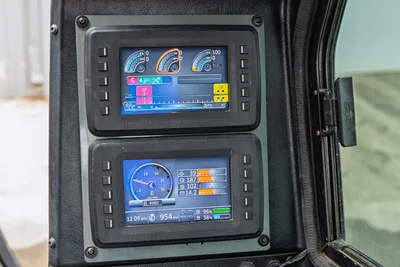 Ditch Witch AT40 dual digital operator displays showing HDD drilling metrics, pressure gauges, and system diagnostics.