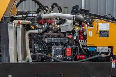 2018 Vermeer D24x40 S3 engine compartment open, showing 125hp diesel engine, turbo, hydraulic filters, and fluid lines