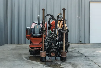 2021 Ditch Witch JT28 HDD drill, rear view showing drill frame, vise assembly, anchors, loaded drill pipe rack, and operator seat