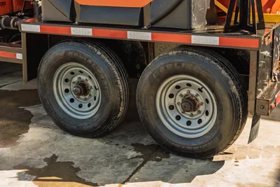 2022 Ditch Witch HX30 mud mixing unit trailer axle with dual Carlisle radial tires, steel wheels, orange frame, reflective tape