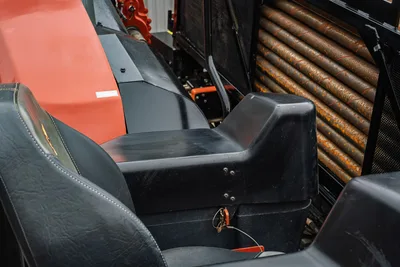 2024 Ditch Witch JT24 operator seat, center console, and drill pipe rack with used 2.25" pipe showing wear marks