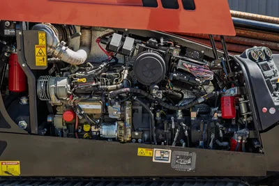 2018 Ditch Witch JT20 engine compartment side view showing clean, maintained hydraulic pump and diesel motor components.
