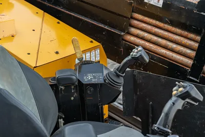 2016 Vermeer D23x30 S3 operator controls: joysticks, seat, control panel, yellow housing, drill pipe rack visible overhead