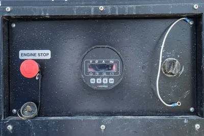 American Augers M300DH mud recycler control panel showing engine stop button, digital V/A/Hz meter, and key switch
