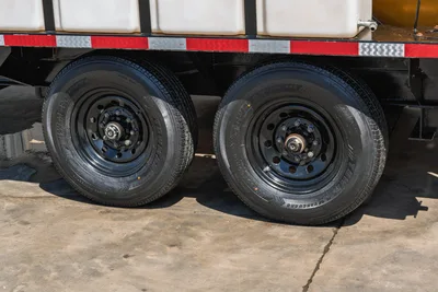 Vermeer LP873SDT vacuum excavator trailer tandem axle with dual Vanguard tires, black steel wheels, red reflective trim strip visible