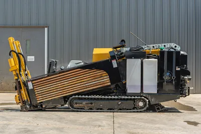 Vermeer 10x15 S3 HDD rig with tracked undercarriage, yellow drill pipe storage, black rotary head, and control cab, side view