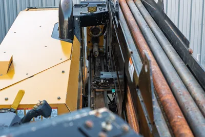 2021 Vermeer D23x30 S3 drill frame overhead view showing thrust/pullback carriage, hydraulic spindle, and loaded drill pipe rack