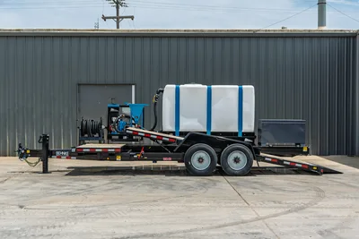 Behnke TBCT2220ET-BT-R HDD mixing trailer, side view, white poly tank with blue straps, blue mud mixer, hose reel, tandem axle, dovetail ramps