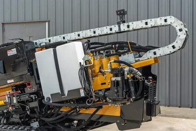2024 Vermeer D20x22 S3 hydraulic system close-up showing cable carrier, fluid tank, pumps, and hose routing