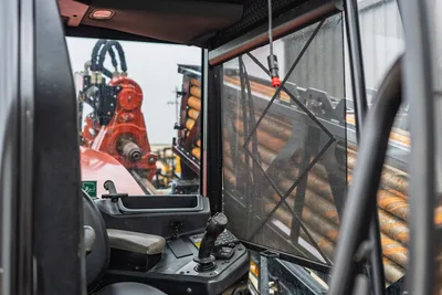 Operator cab view of 2021 Ditch Witch AT40 HDD drill showing joystick controls, drill pipe rack, and rotating head assembly.