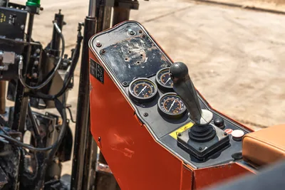 2021 Ditch Witch JT28 operator console, close-up of drill pressure gauges, joystick controls, and worn red panel