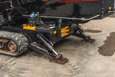 2021 Ditch Witch JT25 lateral view showing tracked undercarriage, hydraulic stabilizer legs, and frame components.