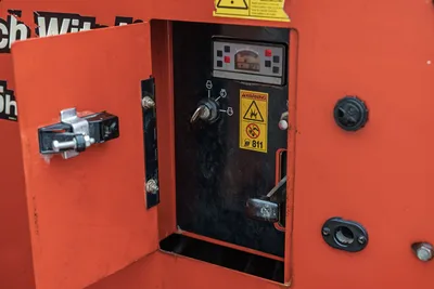 2015 Ditch Witch MR90 open control panel showing hour meter reading 821, key switch, and warning decals