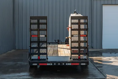 2023 MAXX-D C6X trailer rear view, split fold-down mesh ramps, wood deck, LED lights, red reflectors, mud mixing tank loaded