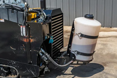 2021 Vermeer D8x12 HDD drill rear view showing engine radiator, hydraulic lines, rubber track, and mounted drilling fluid tank