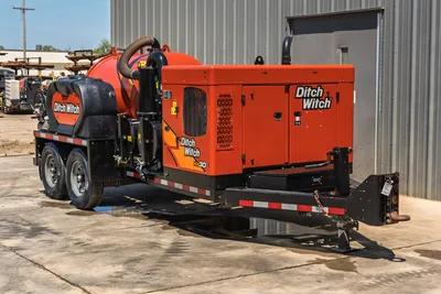 2023 Ditch Witch HX30 mud recycler, 3/4 rear view, trailer-mounted, orange vacuum tank, engine enclosure, flex hose, tandem axle