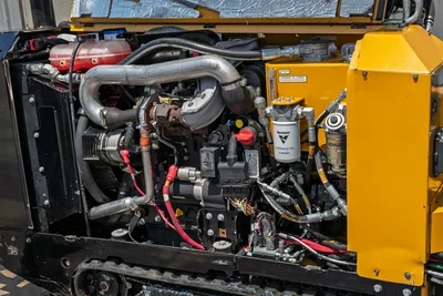 2021 Vermeer D8x12 open engine compartment showing Kohler engine, exhaust manifold, hydraulic oil filter, and harnessing