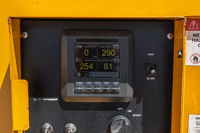 Vermeer LP873SDT vacuum excavator engine control panel displaying 290 hrs, RPM, load, and intake temp; ignition switch visible