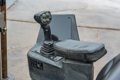 2018 Ditch Witch JT20 operator station joystick controller with ergonomic armrest and control decals, close-up view.