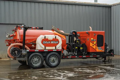 2021 Ditch Witch HX50 mud recycler on tandem-axle trailer, passenger side view, orange vacuum tank, hose reel, pump unit visible