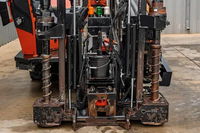 2021 Ditch Witch JT40 front-end close-up showing dual anchor augers, hydraulic cylinders, drill entry box, and warning lights