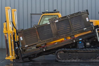 Vermeer 40x55DR S3 HDD drill rig with 40,000 lbs thrust, tracked carrier, yellow and black engine compartment, angled side view showing drill pipe storage