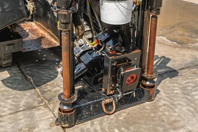 Close-up of Ditch Witch JT10 anchor system, stabilizer legs, and carriage assembly on HDD drill rig in good condition.